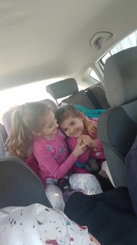 Two girls in pink shirts spotted in car backseat