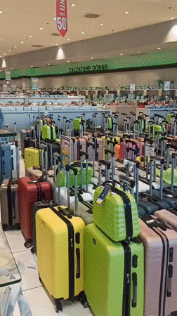 Browsing shoes, bags, and luggage at a Bari retail store