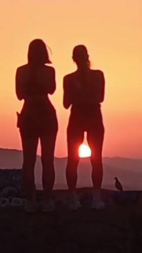 Sunset watch over Barcelona from a graffiti-tagged hilltop viewpoint