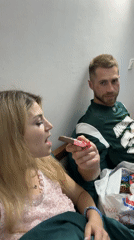 Couple shares candy treats during evening in Budva bedroom