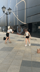Two women perform backflips in Moscow public square