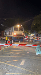 Freight train crosses railroad barrier in Đồng Nai, Vietnam