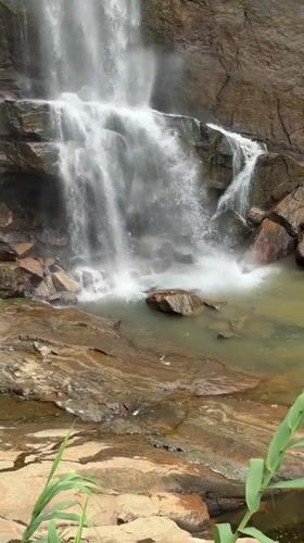Waterfall observed cascading down rocky cliff in Ramboda, Sri Lanka