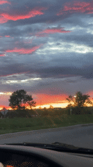 Dramatic pink sunset captured from moving vehicle in Ottawa