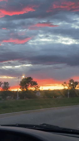 Dramatic pink sunset captured from moving vehicle in Ottawa