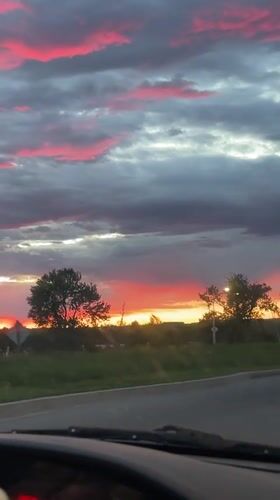 Dramatic pink sunset captured from moving vehicle in Ottawa