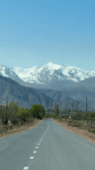 Vehicle drives mountain road in Tong, Kyrgyzstan