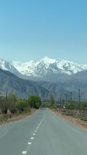 Vehicle drives mountain road in Tong, Kyrgyzstan