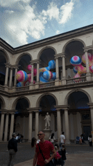 Colorful inflatable art installations displayed in Milan historic courtyard