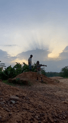 Children play on dirt mound in Ogbu, Nigeria