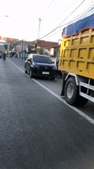 Late afternoon traffic flows through East Java streets