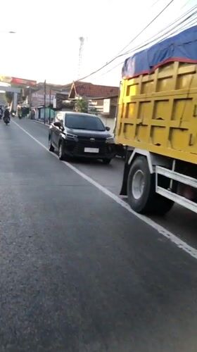 Late afternoon traffic flows through East Java streets