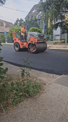 Road crew resurfaces a Hévíz street with paver and roller