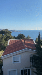 Man observed on balcony overlooking Montenegro coastline