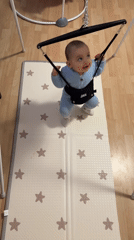 Baby plays in Jolly Jumper bouncer Thursday afternoon