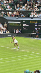 Grass court tennis match at what appears to be Wimbledon