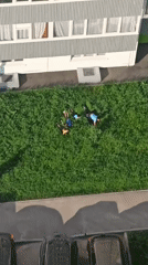 Children play outdoors in Кондратово residential area captured aerially