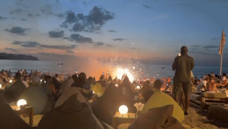 Fire dancers entertain sunset crowd at Thailand beach venue
