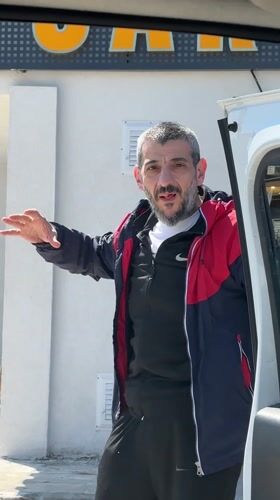 Man handles bag while closing van door in Karaburun