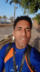 Man with tourism lanyard walks through sunny Porlamar courtyard