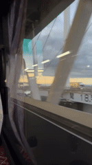 Passenger films white bridge structure from moving vehicle in Yokohama