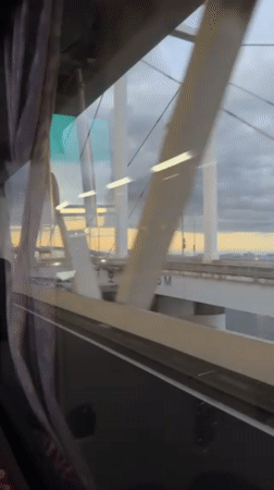 Passenger films white bridge structure from moving vehicle in Yokohama