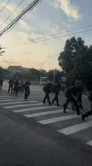 Soldiers cross a Nha Trang street in formation, mid-transit