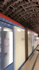 Moscow Metro train departs underground station with distinctive livery