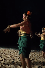 Traditional masked and costumed dance performance on Pattaya beach at night