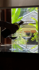 Wine poured outdoors in Kuta Selatan, Indonesia morning scene