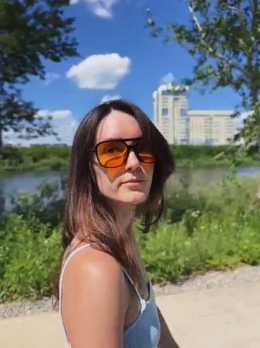 Strolling a Tyumen park path on a sunny June morning
