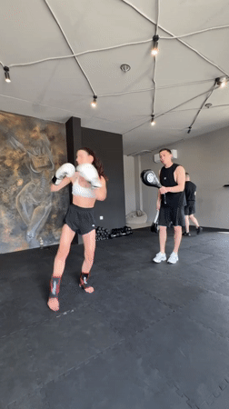 Woman trains kickboxing with instructor at Tyumen gym