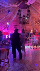 Couples dance under colorful lights at Pattaya entertainment venue