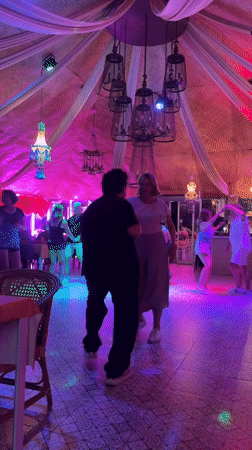 Couples dance under colorful lights at Pattaya entertainment venue