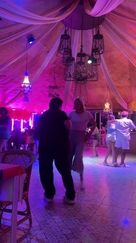 Couples dance under colorful lights at Pattaya entertainment venue