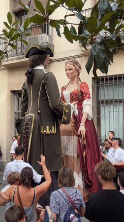 Barcelona street festival with giant parade figures and live music