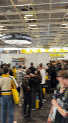 Busy indoor hall with booths observed in Paris