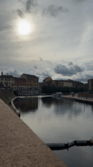 Quiet canal moment captured in Milan under cloudy skies