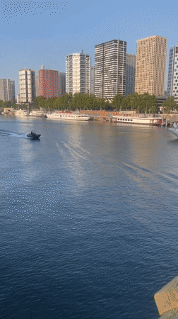 Police patrol boat cuts through the Seine near the Eiffel Tower
