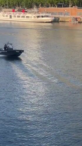 Police patrol boat cuts through the Seine near the Eiffel Tower