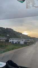 Rainy windshield view on Rukuba Road at golden hour