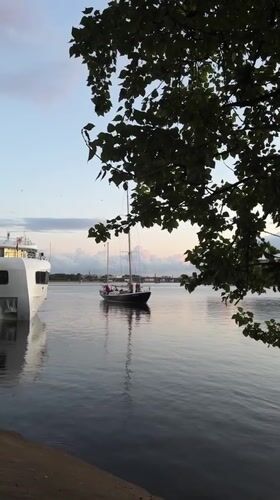 Dusk on the Neva: cruise ships, sailboats, and a Saint Petersburg sunset