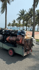 Mobile street vendor sells goods from motorcycle trailer in Da Nang