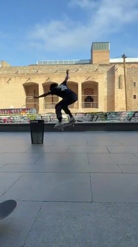 Skateboarders perform tricks in Barcelona plaza during afternoon session