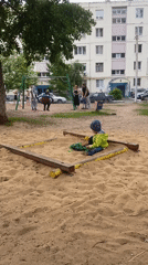 Child plays in sandbox at Orenburg playground