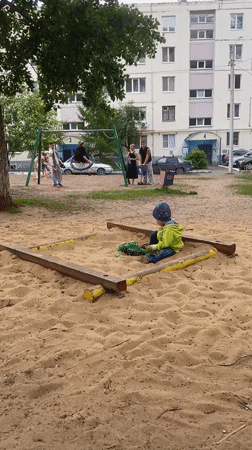 Child plays in sandbox at Orenburg playground