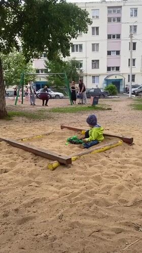 Child plays in sandbox at Orenburg playground