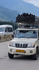 Trucks, roads, and mountain scenery in Chhyal, HP