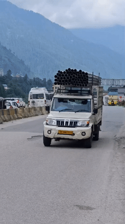 Trucks, roads, and mountain scenery in Chhyal, HP