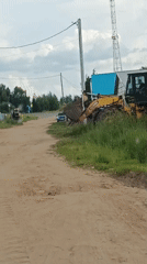 Rural Russia afternoon: construction equipment and dramatic sunset